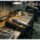 Two automotive coilovers on mechanic's workbench - one new silver coilover upright, one weathered rusty coilover horizontal