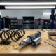 Coilover suspension system and lowering springs on automotive workbench with tools in professional garage setting