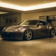 Lowered sports car with aggressive stance parked in modern garage with polished concrete floors and warm lighting.
