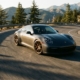 Porsche 911 cornering on mountain road with lowered suspension and performance modifications during golden hour