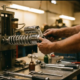 Mechanic adjusting damping knob on chrome motorcycle shock absorber in repair stand with tools on workbench