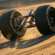 Formula 1 car's chrome rear suspension system with coil spring compressing during cornering, tire sidewall flexing against asphalt track